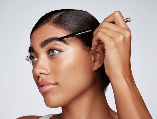 model applying hi-def brow pencil